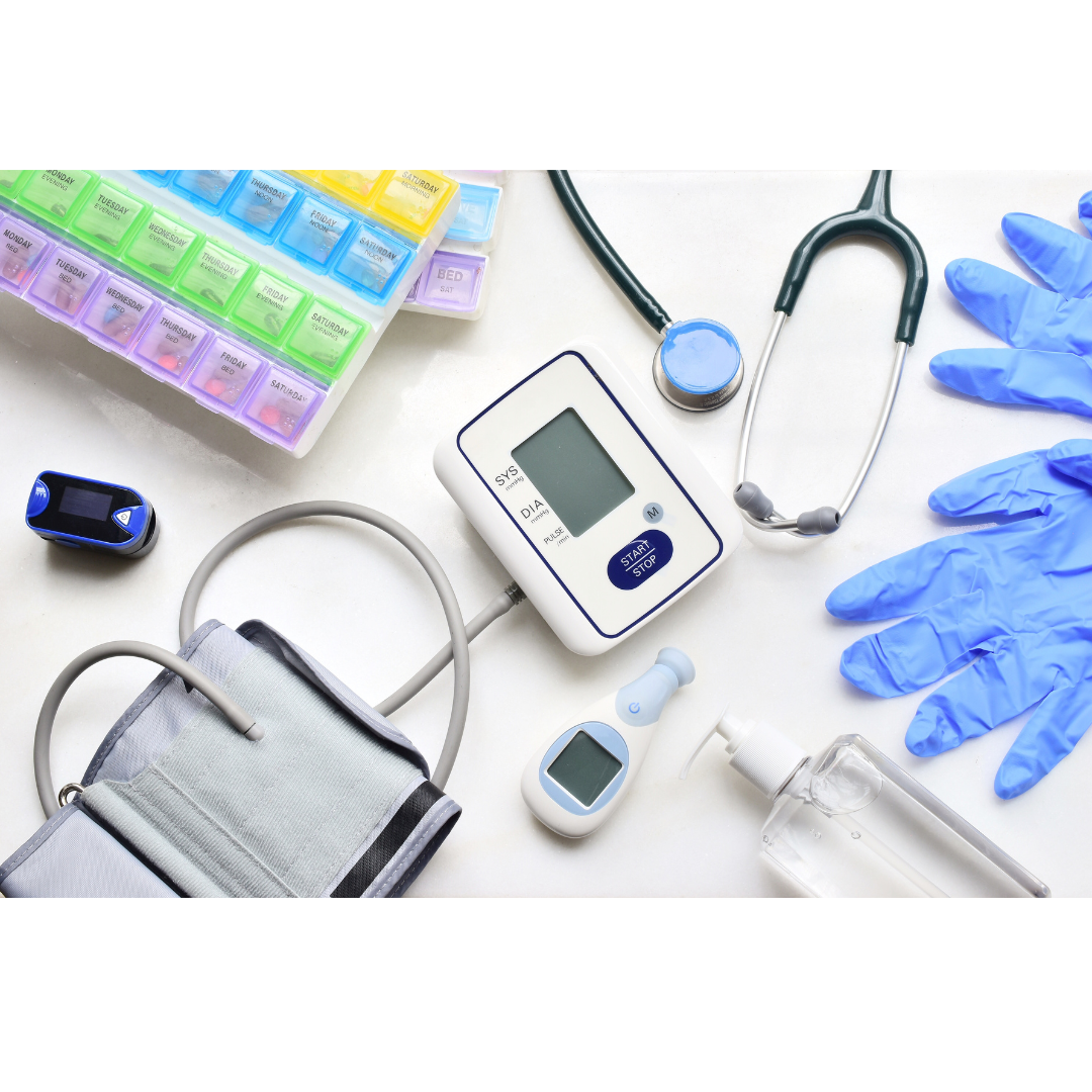 Desk with various healthcare items: pill organizer, stethoscope, latex gloves, and blood pressure cuff.